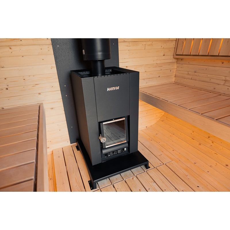 Interior of a wooden sauna with centrally positioned Harvia Sauna heater and two light wood benches facing each other